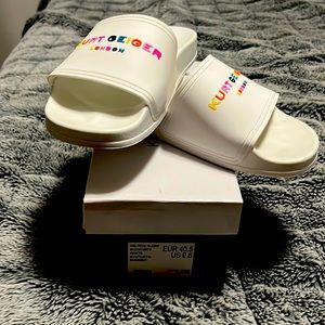 Kurt Geiger white color written slide.